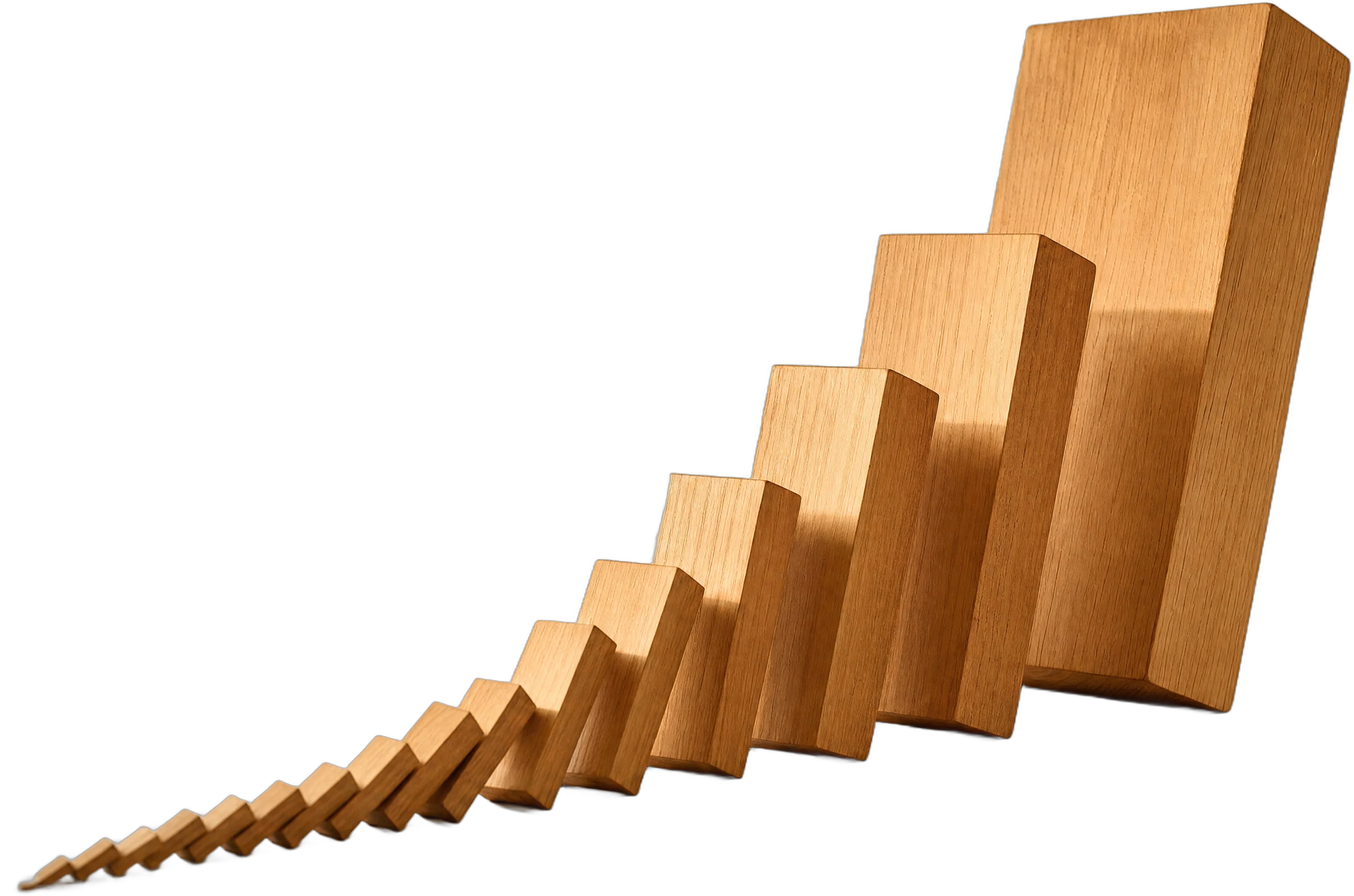 A row of dominoes growing from small to large mid-cascade